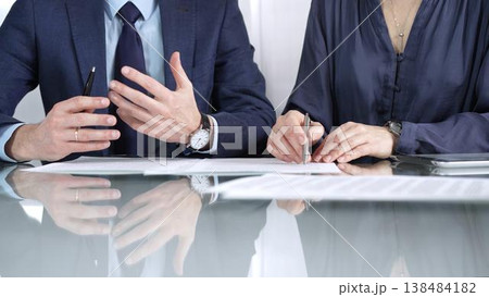 Business partners or lawyers are reviewing contract terms during a meeting, negotiating and making decisions together. Business people concept, close up view Business partners or lawyers are reviewing contract terms during a meeting, negotiating and making decisions together. Business people concept, close up view 138484182