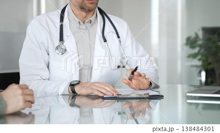 Doctor and patient discussing medical diagnosis, providing healthcare advice during consultation in clinic office. Medicine, health care and science concept Doctor and patient discussing medical diagnosis, providing healthcare advice during consultation in clinic office. Medicine, health care and science concept 138484301