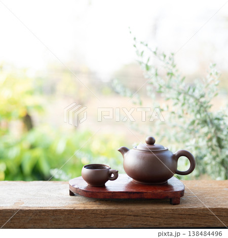 Brown Earthenware tea set on red wooden tray Brown Earthenware tea set on red wooden tray 138484496