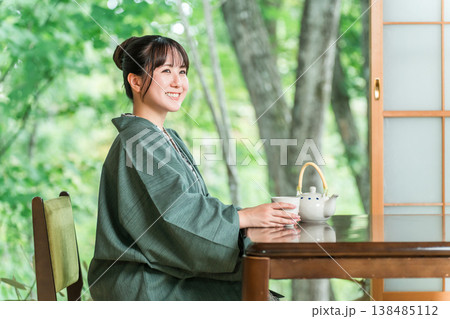 旅館の和室でお茶を飲む浴衣姿の若いアジア人女性 旅館の和室でお茶を飲む浴衣姿の若いアジア人女性 138485112