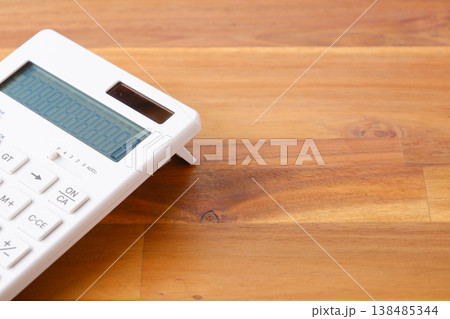 電卓 - テーブルの上に置かれた、白い電卓 電卓 - テーブルの上に置かれた、白い電卓 138485344
