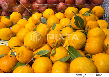 Fresh oranges with green leaves at fruit market Fresh oranges with green leaves at fruit market 138486492