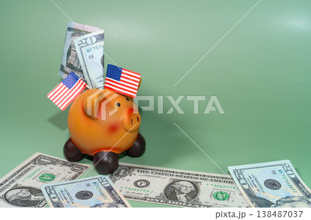 A cheerful piggy bank adorned with American flags is surrounded by US currency on a green backdrop, symbolizing savings and finance. A cheerful piggy bank adorned with American flags is surrounded by US currency on a green backdrop, symbolizing savings and finance. 138487037