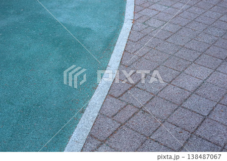 Urban pavement with green rubber playground surface curve 138487067