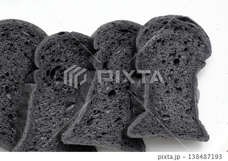 Black charcoal bread slices on white background 138487193