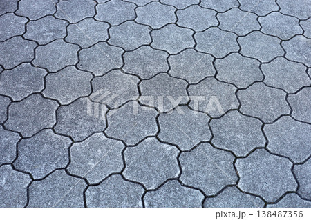 Gray star-shaped stone tiles covering the outdoor walkway. Gray star-shaped stone tiles covering the outdoor walkway. 138487356