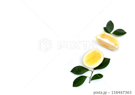 Fresh lemon with green leaves on white. Fresh lemon with green leaves on white. 138487363