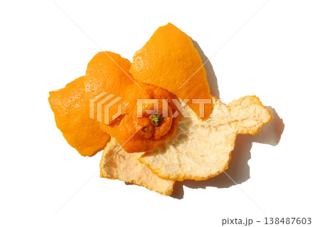 Fresh orange peels on a white surface. Fresh orange peels on a white surface. 138487603