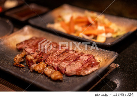 Teppanyaki beef, a Japanese style dish of steak, grilled on a flat iron plate or teppan. Served on a plate 138488324
