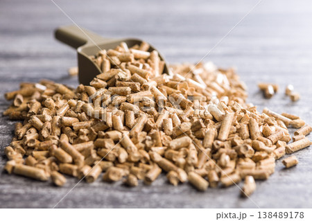 Wood Pellets With Metal Scoop On Concrete Surface For Biomass Fuel And Heating Use Wood Pellets With Metal Scoop On Concrete Surface For Biomass Fuel And Heating Use 138489178