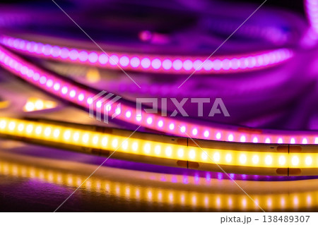 Colorful LED strip lights with reflections on dark surface 138489307