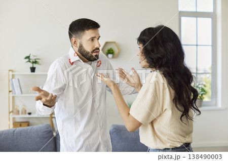 Shocked Couple Arguing at Home After Finding Lipstick Marks on Mans Shirt 138490003