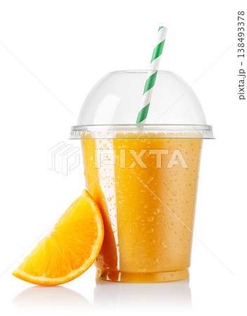 Freshly squeezed cold orange juice in disposable plastic cup with domed lid and slice isolated on white Freshly squeezed cold orange juice in disposable plastic cup with domed lid and slice isolated on white 138493378