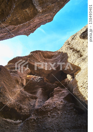Slot Canyon Rock Walls and Blue Sky from Below in Arizona 138493401