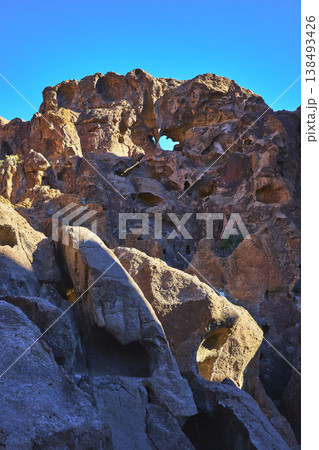 Rock Arch and Hole in the Wall Formation with Blue Sky in Mojave Desert 138493426