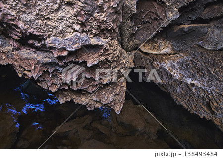 Lava Tube Rock Formations and Blue Light in Mojave Cave Interior 138493484