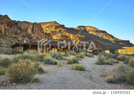 Desert Visitors Center With Rocky Cliffs and Native Plants in Warm Evening Light 138493501