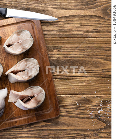 Raw mackerel fish steaks on wooden board 138493656