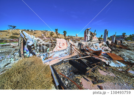 Abandoned Graffiti Covered Ruins and Palm Trees in Desert at Lake Dolores Water Park 138493759