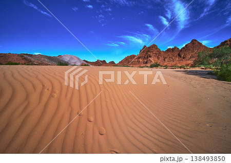 Sand Dune Patterns Red Rock Mountains and Dramatic Sky Nevada Desert Landscape 138493850