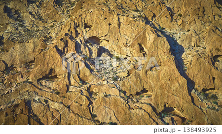 Aerial Desert Rock Face Texture and Sunlit Cliffs in Nevada Aerial Desert Rock Face Texture and Sunlit Cliffs in Nevada 138493925
