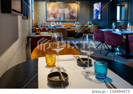 Chic dining environment arranged for professional meetings with modern furniture and artistic accents Chic dining environment arranged for professional meetings with modern furniture and artistic accents 138494073