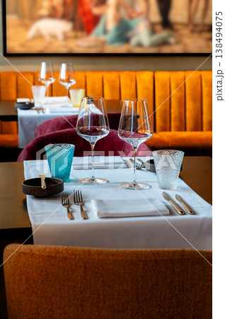Bright table with colorful decor. Lively dining area adorned with bold hues and elegant furnishings Bright table with colorful decor. Lively dining area adorned with bold hues and elegant furnishings 138494075