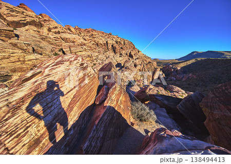 Red Rock Canyon Shadow Silhouette on Sunlit Rocks with Blue Sky Nevada Red Rock Canyon Shadow Silhouette on Sunlit Rocks with Blue Sky Nevada 138494413