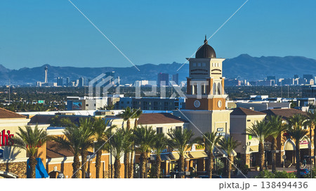 Aerial Las Vegas Shopping Center Palm Trees and Distant Strip Skyline at Golden Hour Aerial Las Vegas Shopping Center Palm Trees and Distant Strip Skyline at Golden Hour 138494436