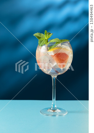 Cocktail gin and tonic with ice and grapefruit slices. Cocktail gin and tonic with ice and grapefruit slices. 138494463