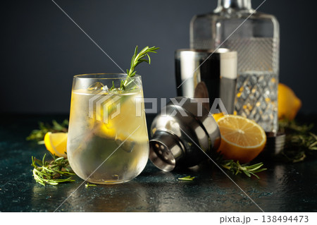 Cocktail gin tonic with natural ice, lemon, and rosemary. 138494473