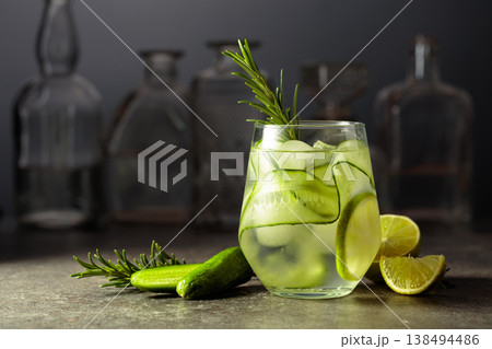 Cocktail gin tonic with ice, rosemary, lime, and cucumber. Cocktail gin tonic with ice, rosemary, lime, and cucumber. 138494486
