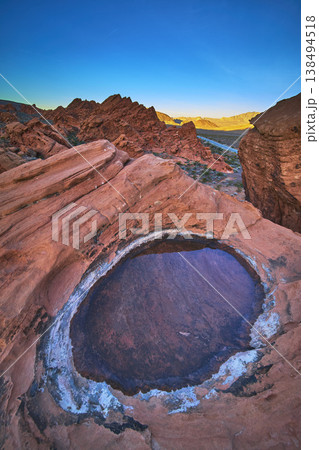 Redstone Dune Desert Tinaja With Water at Sunrise in Nevada Redstone Dune Desert Tinaja With Water at Sunrise in Nevada 138494518