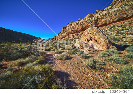 Red Rock Canyon Guardian Angel Trail Desert Landscape with Dramatic Boulder and Blue Sky Red Rock Canyon Guardian Angel Trail Desert Landscape with Dramatic Boulder and Blue Sky 138494564