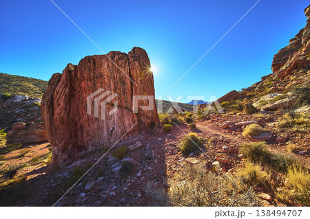 Red Rock Canyon Guardian Angel Rock Sunburst and Desert Trail in Bright Nevada Landscape Red Rock Canyon Guardian Angel Rock Sunburst and Desert Trail in Bright Nevada Landscape 138494707