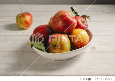 Red apples from garden, in a bowl lifestyle, top view. Autumn abstract food background. Copy space Red apples from garden, in a bowl lifestyle, top view. Autumn abstract food background. Copy space 138495091
