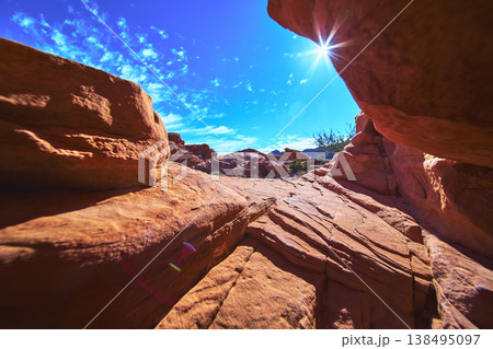 Red Sandstone Arch Sunburst and Desert Landscape in Valley of Fire Nevada Red Sandstone Arch Sunburst and Desert Landscape in Valley of Fire Nevada 138495097