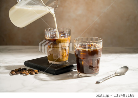 Glass with iced latte, refreshing energy coffee drinks Glass with iced latte, refreshing energy coffee drinks 138495169