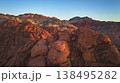 Aerial Red Rock Canyon Rugged Sandstone Formations and Mountains at Sunrise 138495282