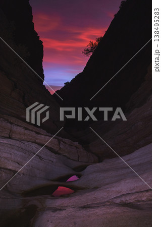 Vivid Blue Hour Light Over Dramatic Slot Canyon Rock Walls and Reflective Pools Vivid Blue Hour Light Over Dramatic Slot Canyon Rock Walls and Reflective Pools 138495283