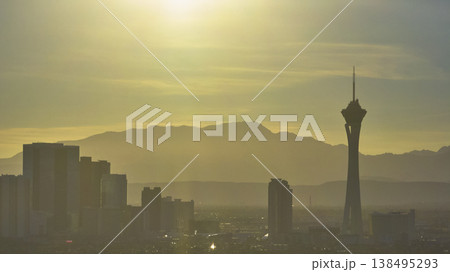 Aerial Las Vegas Strip Skyline Stratosphere Tower and Mountains Golden Hour 138495293