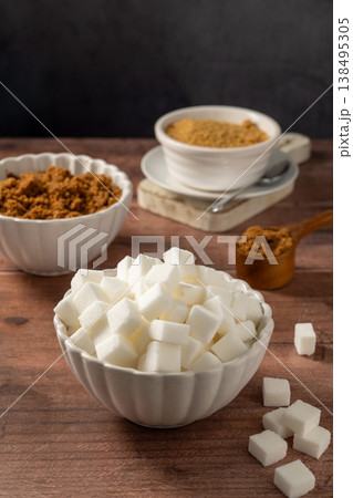 Light brown, dark brown and white sugar cubes in bowls. Different type of sugar Light brown, dark brown and white sugar cubes in bowls. Different type of sugar 138495305