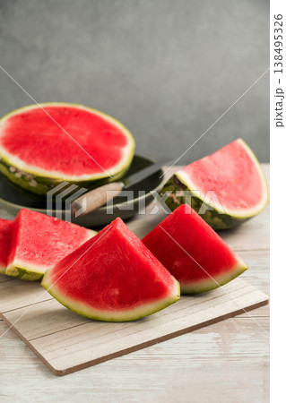 Slices of fresh watermelon on bright rustic wooden table 138495326