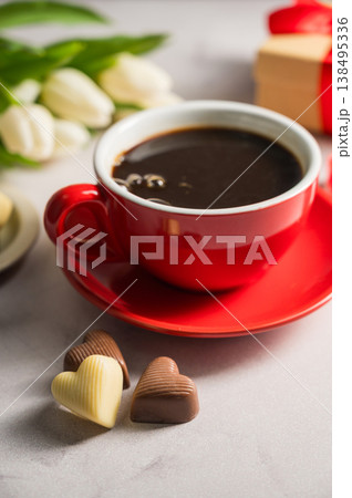 Valentine's day. Cup of coffee, heart chocolates, gift box and spring white tulip flower bouquet. Mother's day Valentine's day. Cup of coffee, heart chocolates, gift box and spring white tulip flower bouquet. Mother's day 138495336