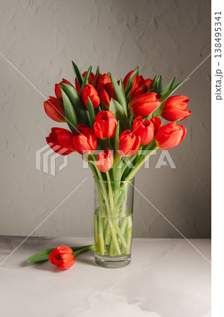 Spring flowers in a vase. A bouquet of fresh red tulips, birthday or easter background 138495341