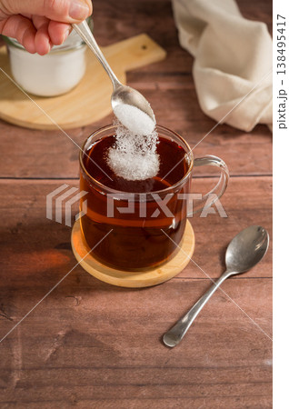 Pouring sweetener powder in cup of tea. Sugar alternative, food and nutrition Pouring sweetener powder in cup of tea. Sugar alternative, food and nutrition 138495417