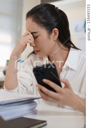 Stressed businesswoman reacting to financial loss and investment risk after checking smartphone 138495553