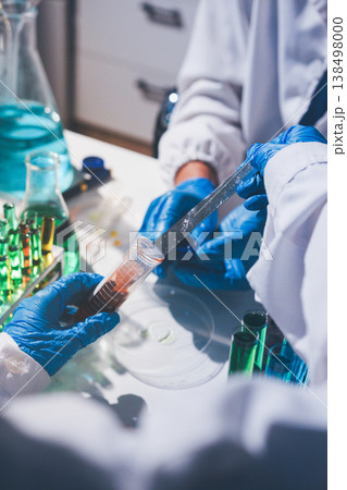 Science, laboratory and woman with pipette, test tube and biotech solution in research. Medical innovation, scientist or lab technician in study for healthcare, medicine and vaccine results feedback. Science, laboratory and woman with pipette, test tube and biotech solution in research. Medical innovation, scientist or lab technician in study for healthcare, medicine and vaccine results feedback. 138498000