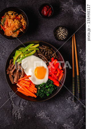 Traditional Korean dish Bibimbap: rice with vegetables beef and egg. Traditional Korean dish Bibimbap: rice with vegetables beef and egg. 138498117