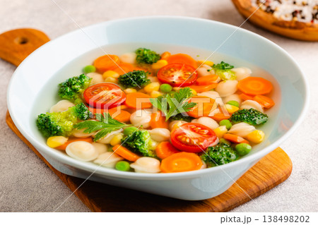 Soup with mini dumplings and vegetables. 138498202